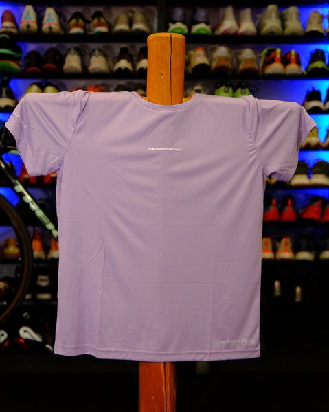 Purple shirt on a wooden hanger against a colorful background